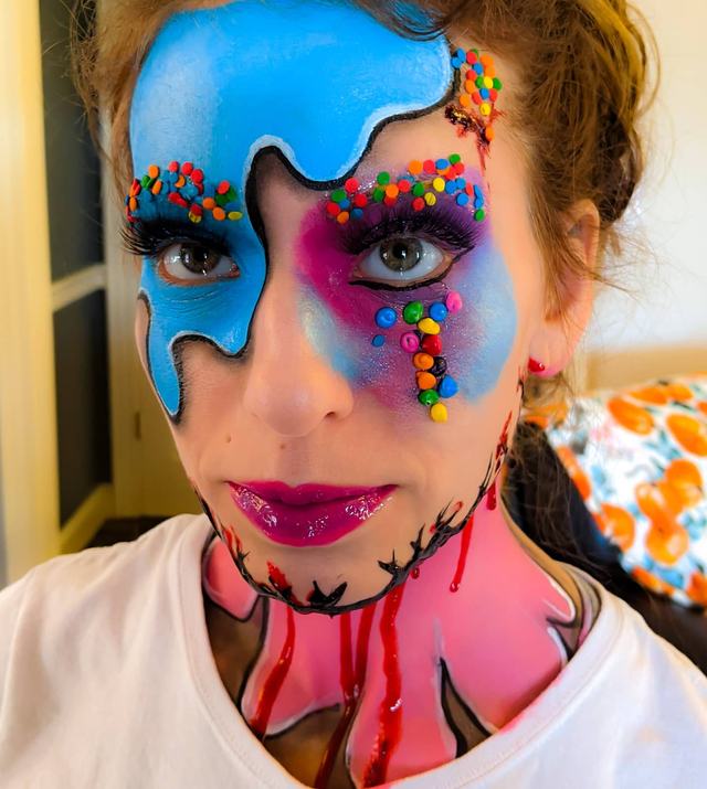 Candy-drip face: bright blue drips studded with sprinkles, with candy-pink lips