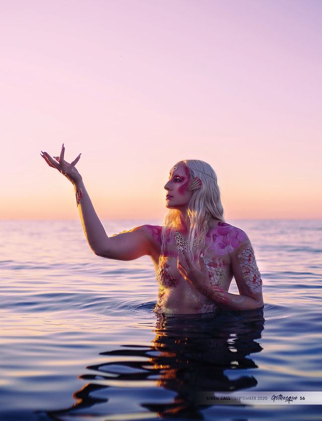 Dark Water: figure in the lake with one arm raised at sunset
