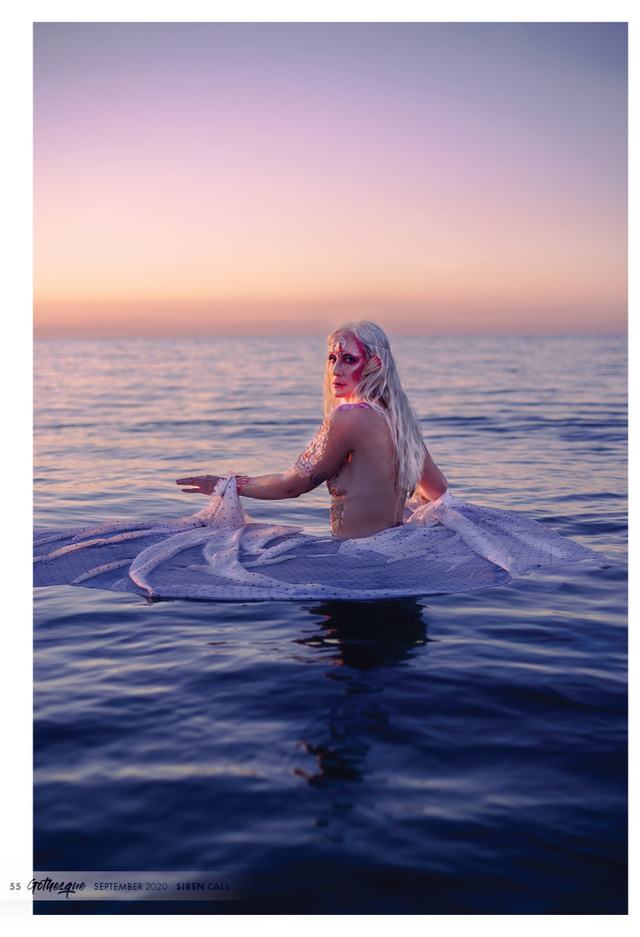 Dark Water: figure in a pale gown sitting in the water