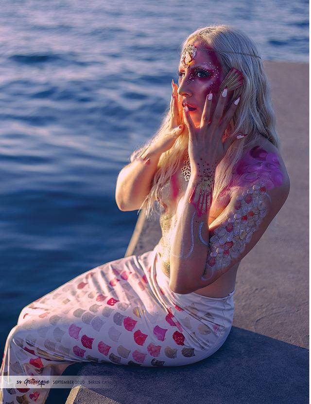 Dark Water: painted figure on a dock, hand to face