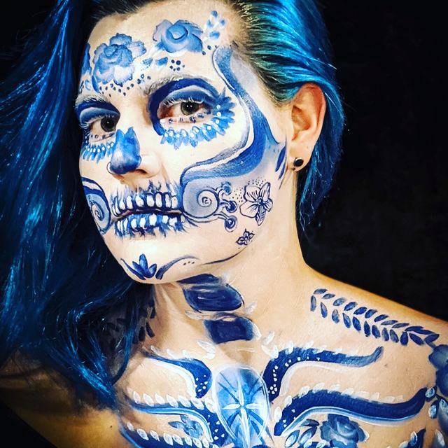 Sugar skull in Delft blue and white, with ornamental painting down the neck and shoulders
