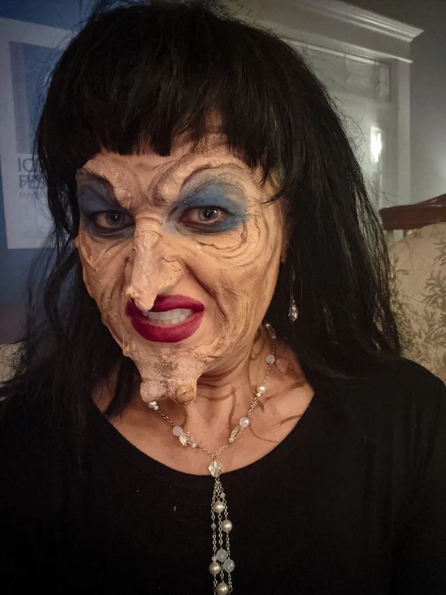 The Grand High Witch recreated: sculpted hooked nose and chin, wrinkled skin, moles and a black wig