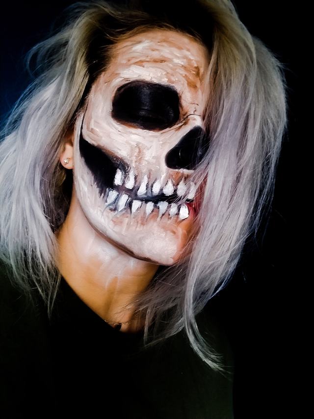 Realistic grinning skull with sunken cheeks