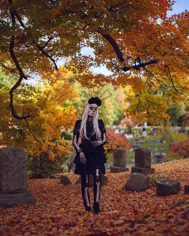 Full-length view of the halo sugar-skull look in an autumn cemetery