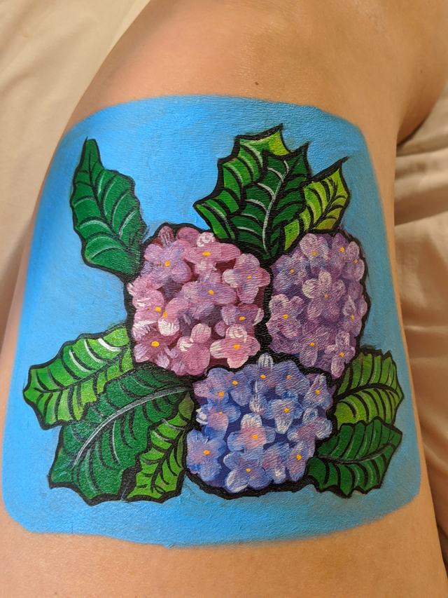 Purple and pink hydrangea on a blue ground, painted on a forearm