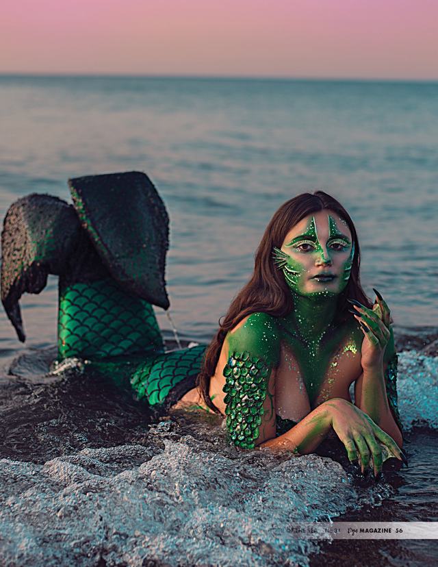 Juniper of the Sea: mermaid with webbed fingers and green scales at the water’s edge