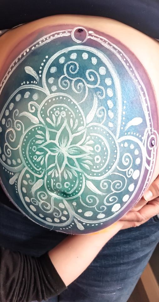 Maternity belly painting: a teal and white mandala