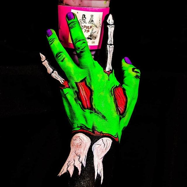 Green monster hand with painted bones and claws