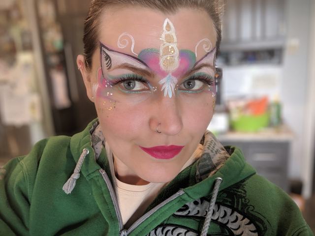 Pastel unicorn mask with a painted horn and jewels
