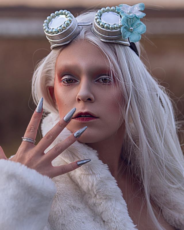 Snow Queen portrait: pale skin, goggles and long silver nails