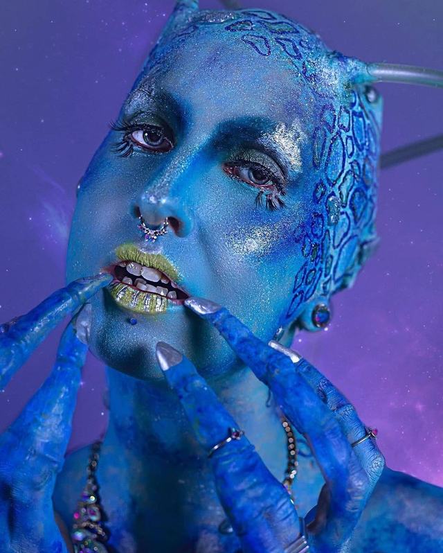 Space Babe close-up, hands painted blue with silver accents