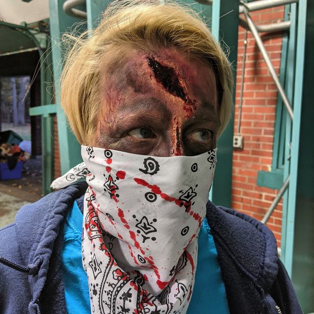 Zombie with a deep forehead gash and a bandana over the mouth
